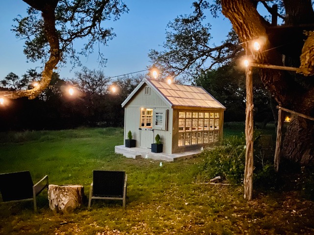 Greenhouse at dusk with string lights