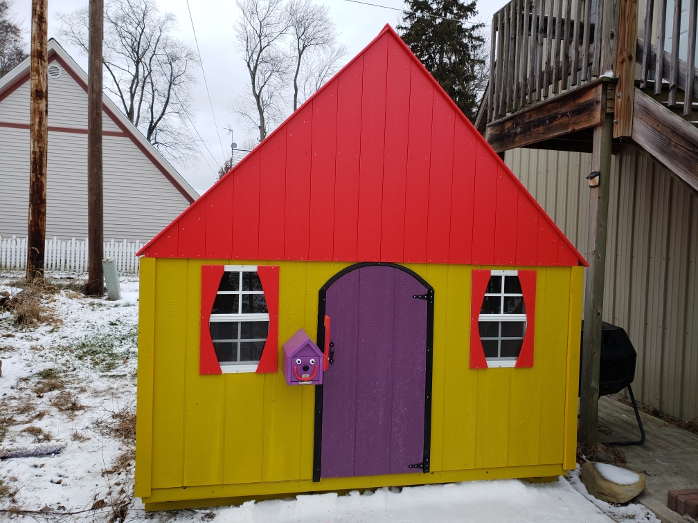 Custom yellow and red playhouse built for a wish kid