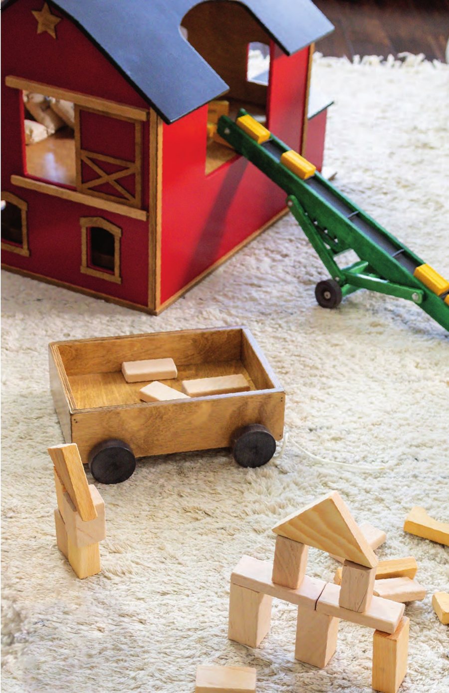 Red wooden barn with the farm elevator running into the loft and a wagon of blocks