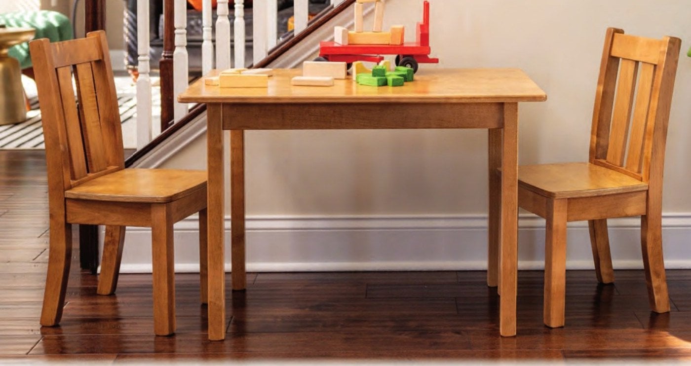 Harvest wooden kids' table with two slat-back chairs in a family room