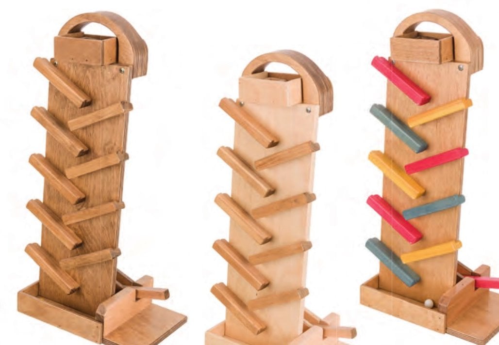 Three wooden marble launchers in harvest, harvest and natural, and red, yellow and blue