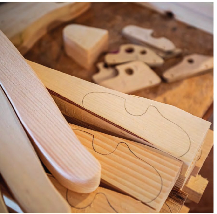 Wooden horse-head patterns traced on pine boards